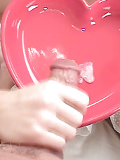 Blonde gives her lover a blowjob then licks his cum from a red shaped bowl
